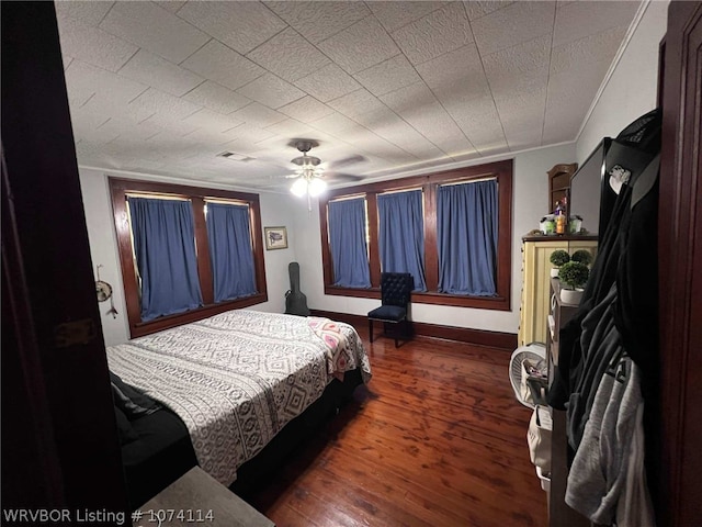 bedroom featuring ceiling fan and dark wood-type flooring