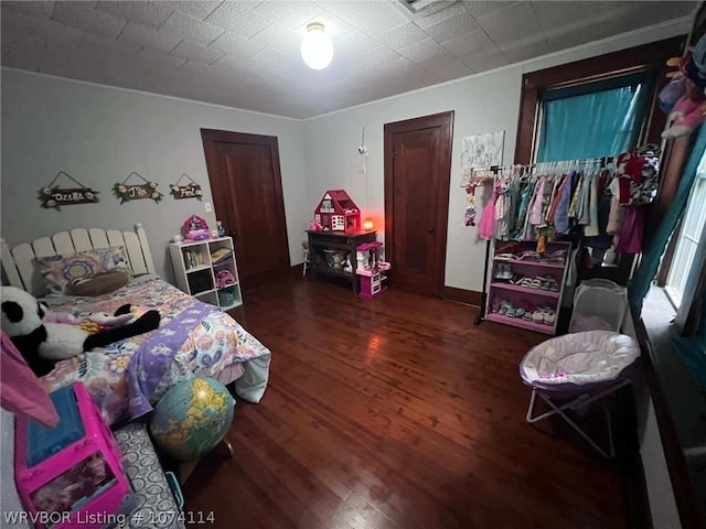 bedroom with dark wood-type flooring