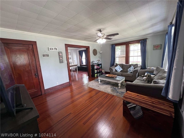 living room with crown molding, dark hardwood / wood-style flooring, and ceiling fan