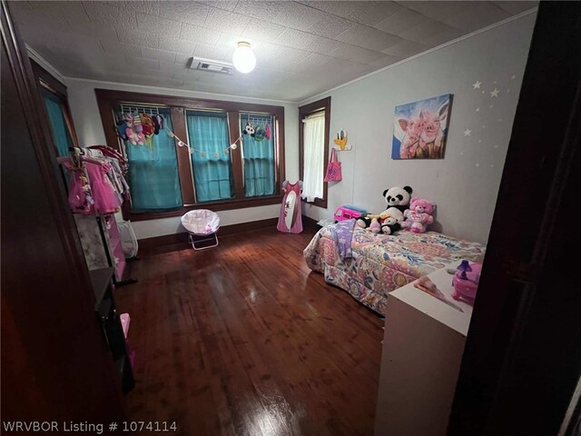 bedroom featuring dark hardwood / wood-style floors and ornamental molding