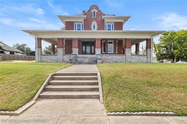 view of front of home with a porch and a front yard