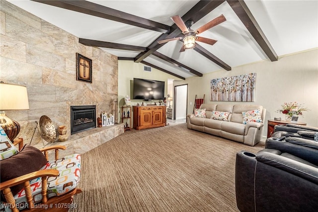 carpeted living room with ceiling fan, lofted ceiling with beams, and a premium fireplace