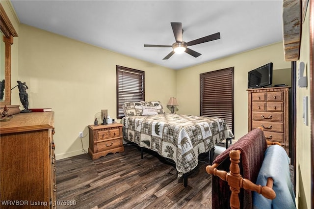 bedroom with dark hardwood / wood-style floors and ceiling fan