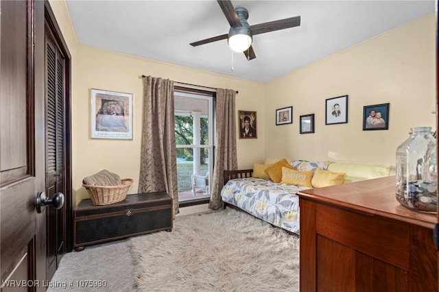 bedroom with ceiling fan, a closet, and light carpet