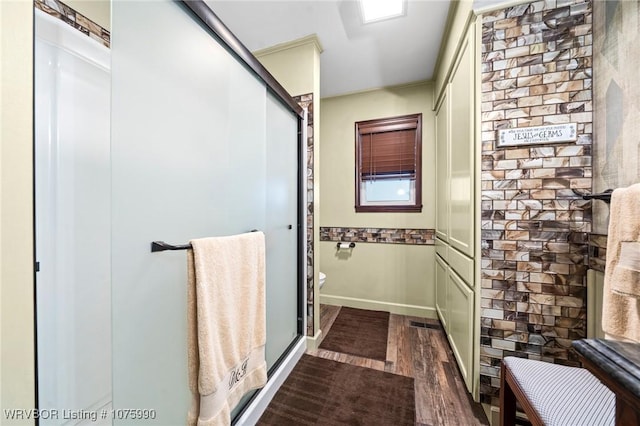 bathroom featuring wood-type flooring and toilet