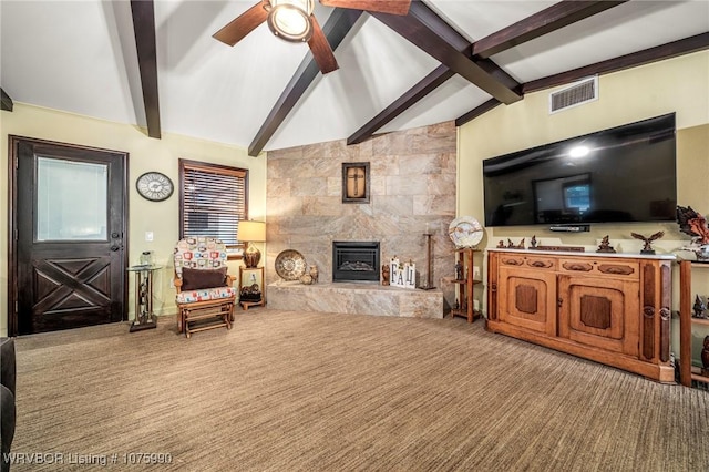 carpeted living room with lofted ceiling with beams, ceiling fan, and a high end fireplace