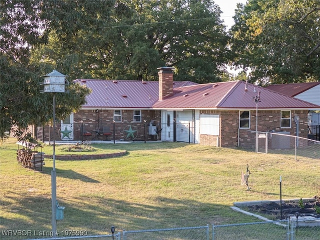 rear view of house featuring a yard