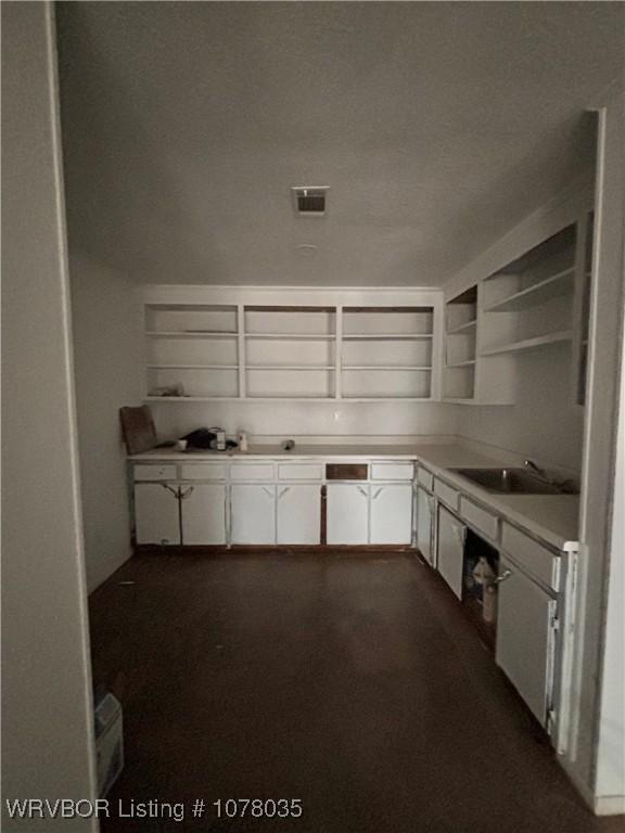 kitchen with white cabinetry and sink