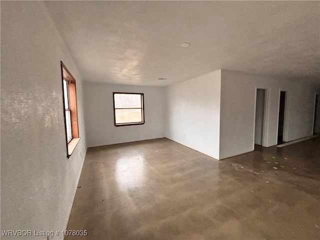 unfurnished room featuring concrete floors