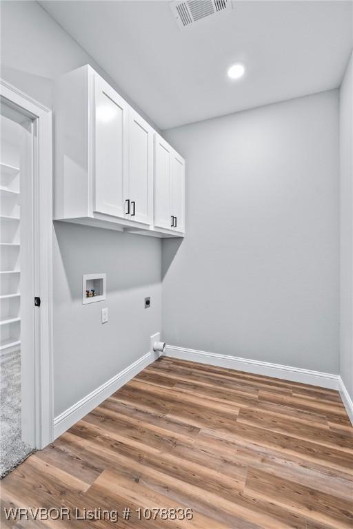 2006 Yellowstone Dr, Barling, AR 72923 - laundry area with washer hookup, hardwood / wood-style flooring, cabinets, and hookup for an electric dryer