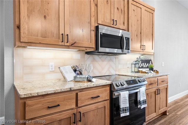 2006 Yellowstone Dr, Barling, AR 72923 - kitchen with tasteful backsplash, stainless steel appliances, light stone countertops, and hardwood / wood-style flooring