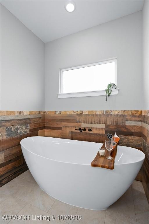 2006 Yellowstone Dr, Barling, AR 72923 - bathroom featuring tile patterned floors, a bathtub, and tile walls