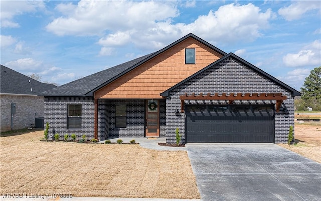 view of front of home featuring a garage and central AC