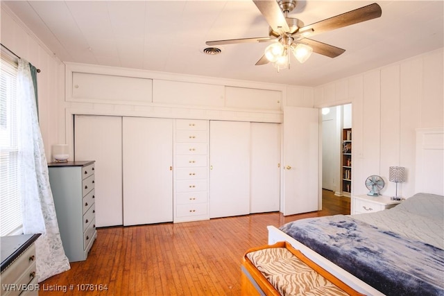 bedroom with hardwood / wood-style flooring, ceiling fan, and a closet