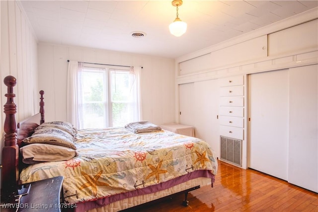 bedroom with hardwood / wood-style floors and crown molding