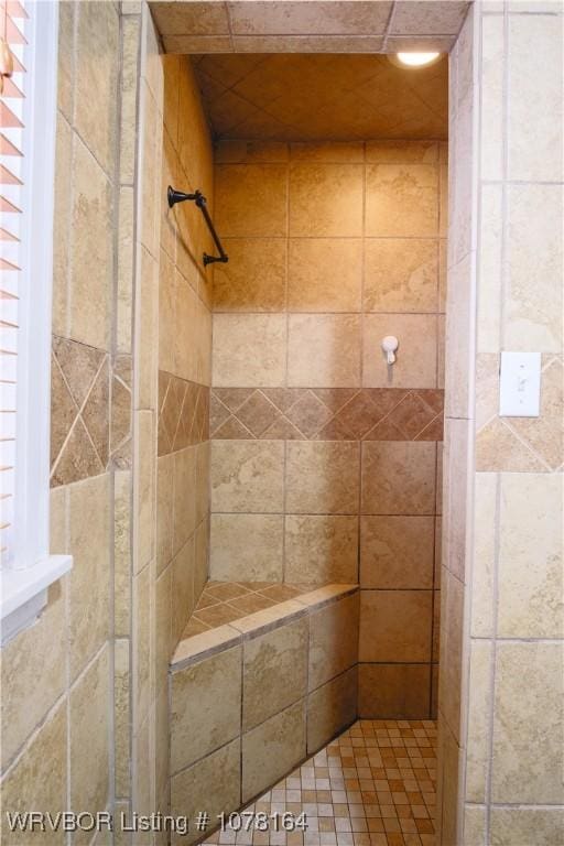 bathroom with tiled shower