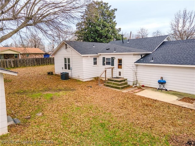 rear view of house with central AC unit and a patio area