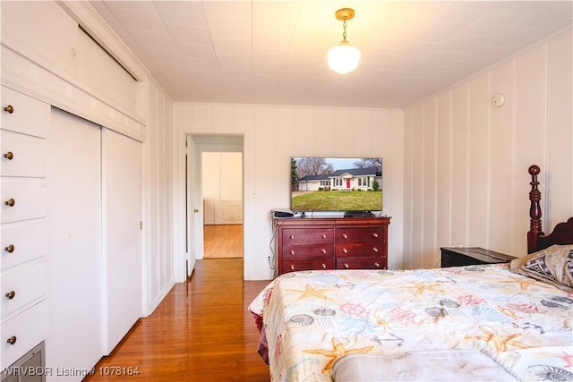 bedroom featuring wood-type flooring and a closet