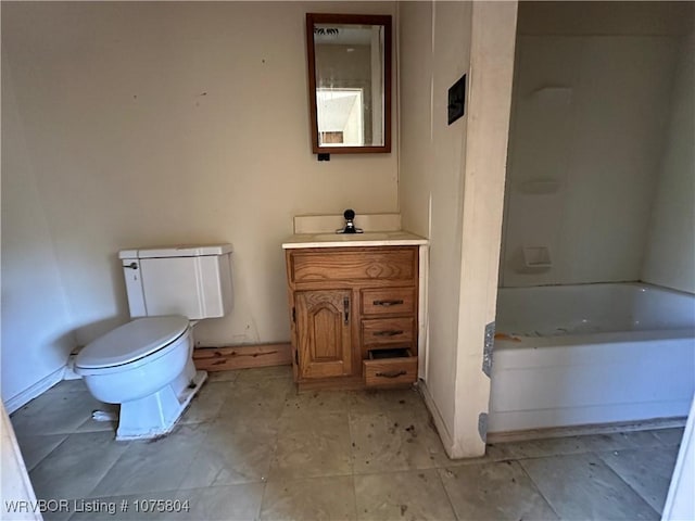 bathroom with vanity, toilet, and a tub to relax in