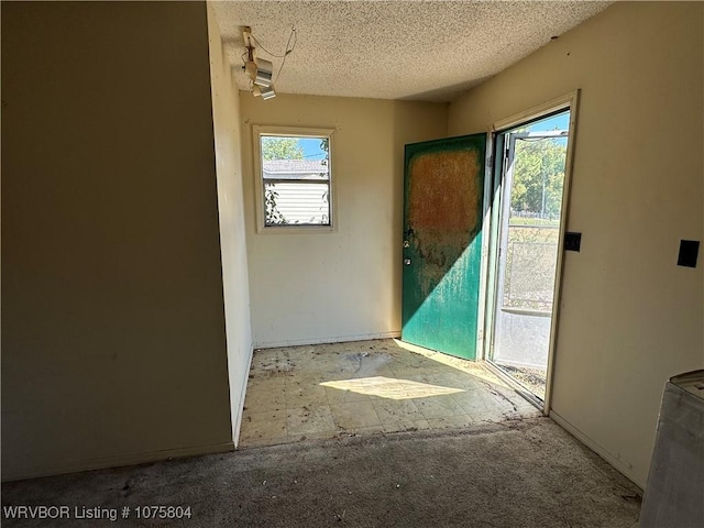 entryway featuring a textured ceiling