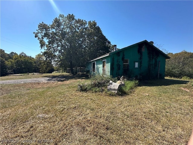 view of property exterior featuring a lawn