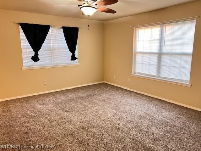 spare room with carpet floors and ceiling fan