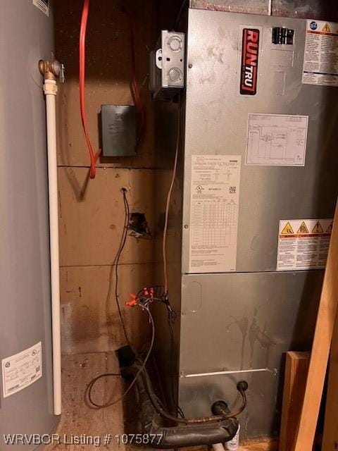 utility room with heating unit and water heater