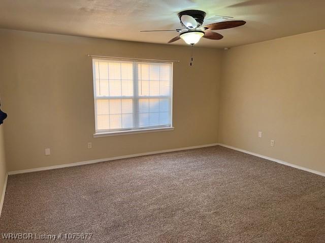 unfurnished room featuring ceiling fan and carpet