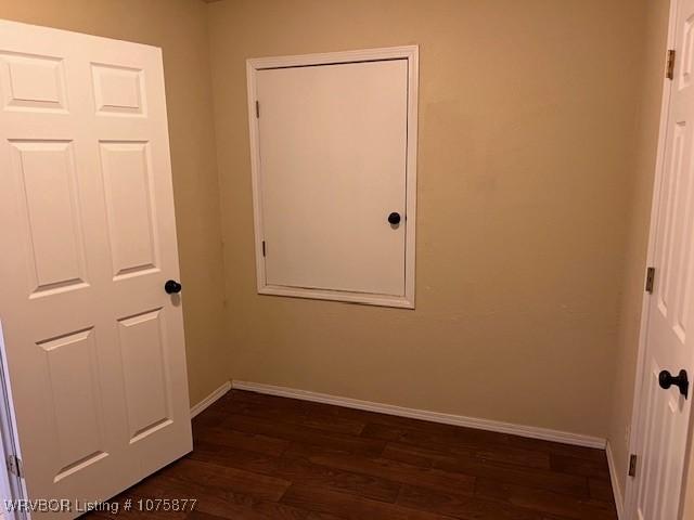 unfurnished room featuring dark hardwood / wood-style flooring