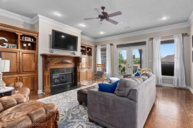 6800 Highland Park Dr, Fort Smith, AR 72916 - living room with wood finished floors, french doors, a fireplace, a ceiling fan, and crown molding