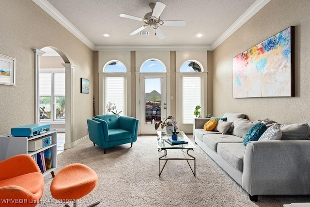 6800 Highland Park Dr, Fort Smith, AR 72916 - carpeted living area with arched walkways, a textured wall, ceiling fan, decorative columns, and ornamental molding