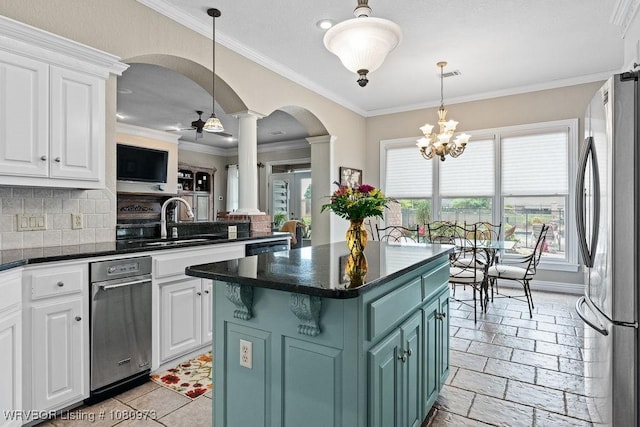 6800 Highland Park Dr, Fort Smith, AR 72916 - kitchen with freestanding refrigerator, ornate columns, a sink, arched walkways, and white cabinetry