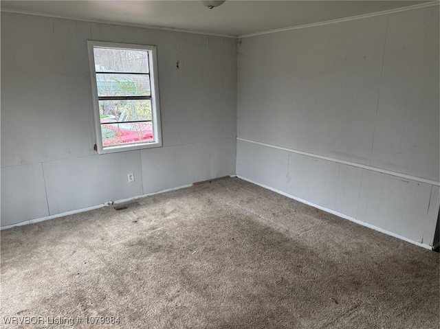 unfurnished room featuring carpet and crown molding