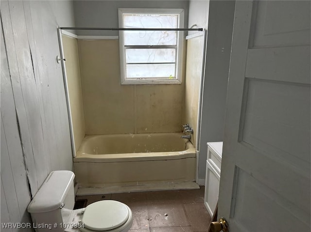 full bath featuring toilet, wood walls, bathing tub / shower combination, and vanity