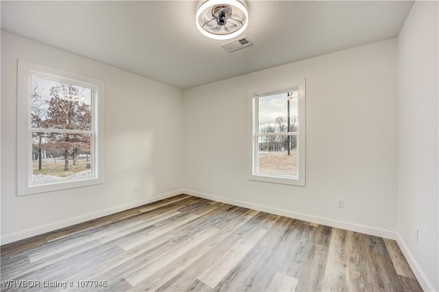 unfurnished room with light hardwood / wood-style floors