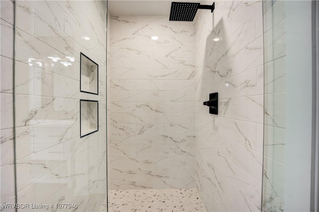 bathroom with a tile shower