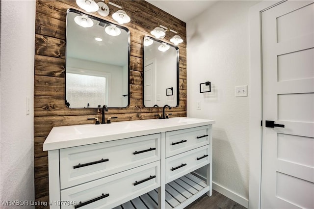 bathroom featuring wood walls, vanity, and wood-type flooring