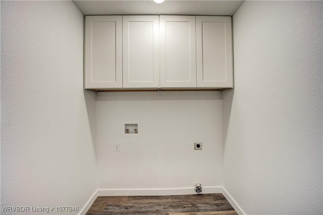 clothes washing area featuring washer hookup, electric dryer hookup, dark hardwood / wood-style flooring, and cabinets