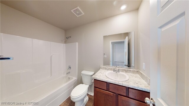 full bathroom with shower / bathing tub combination, vanity, toilet, and hardwood / wood-style floors