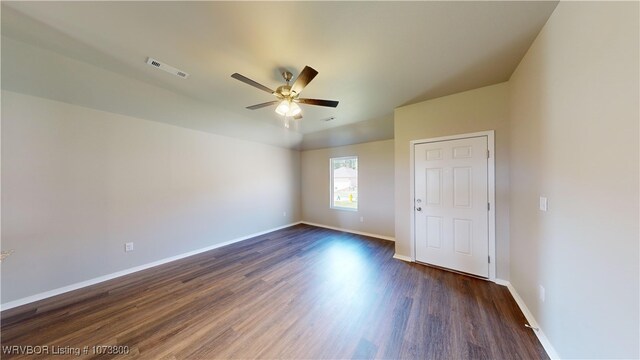 empty room featuring ceiling fan and dark wood-type flooring