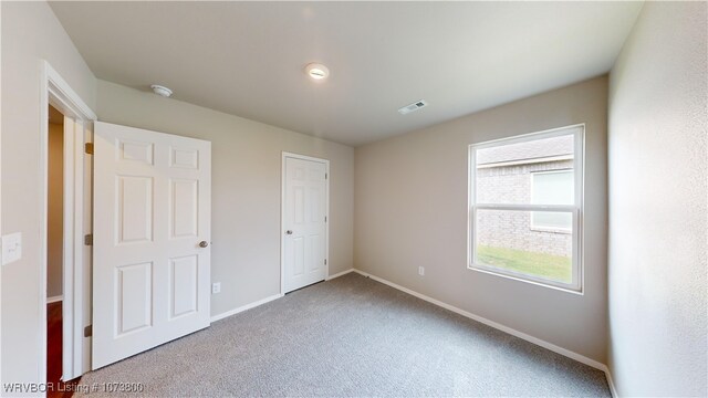 unfurnished bedroom with carpet and a closet