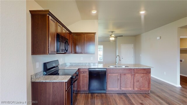 kitchen featuring black appliances, sink, ceiling fan, light stone countertops, and kitchen peninsula