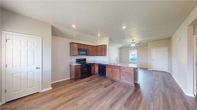 kitchen featuring kitchen peninsula, ceiling fan, sink, black appliances, and dark hardwood / wood-style floors