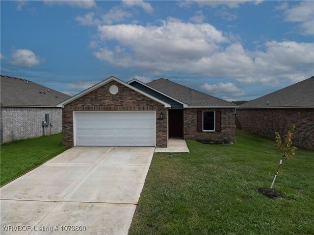 single story home featuring a front lawn and a garage