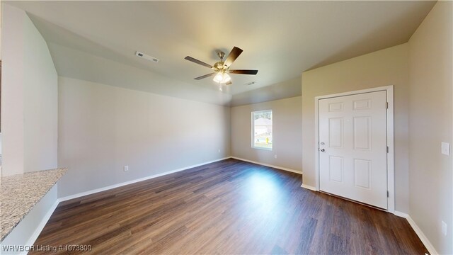 interior space featuring ceiling fan, dark hardwood / wood-style flooring, and vaulted ceiling