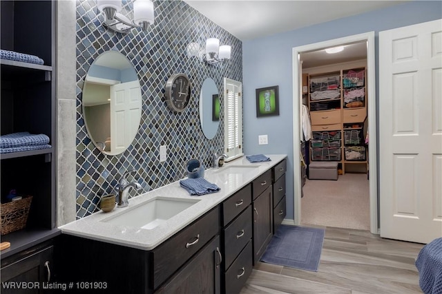 1232 Elizabeth Ln, Fort Smith, AR 72903 - full bathroom with double vanity, a walk in closet, and wood finished floors