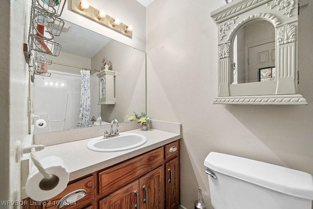 bathroom featuring vanity, a shower with shower curtain, and toilet