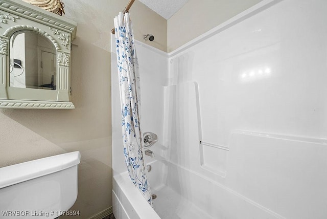 bathroom featuring shower / bathtub combination with curtain and toilet