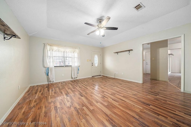 interior space with ceiling fan, hardwood / wood-style floors, and a textured ceiling