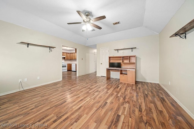 unfurnished living room with dark wood-type flooring, ceiling fan, and vaulted ceiling